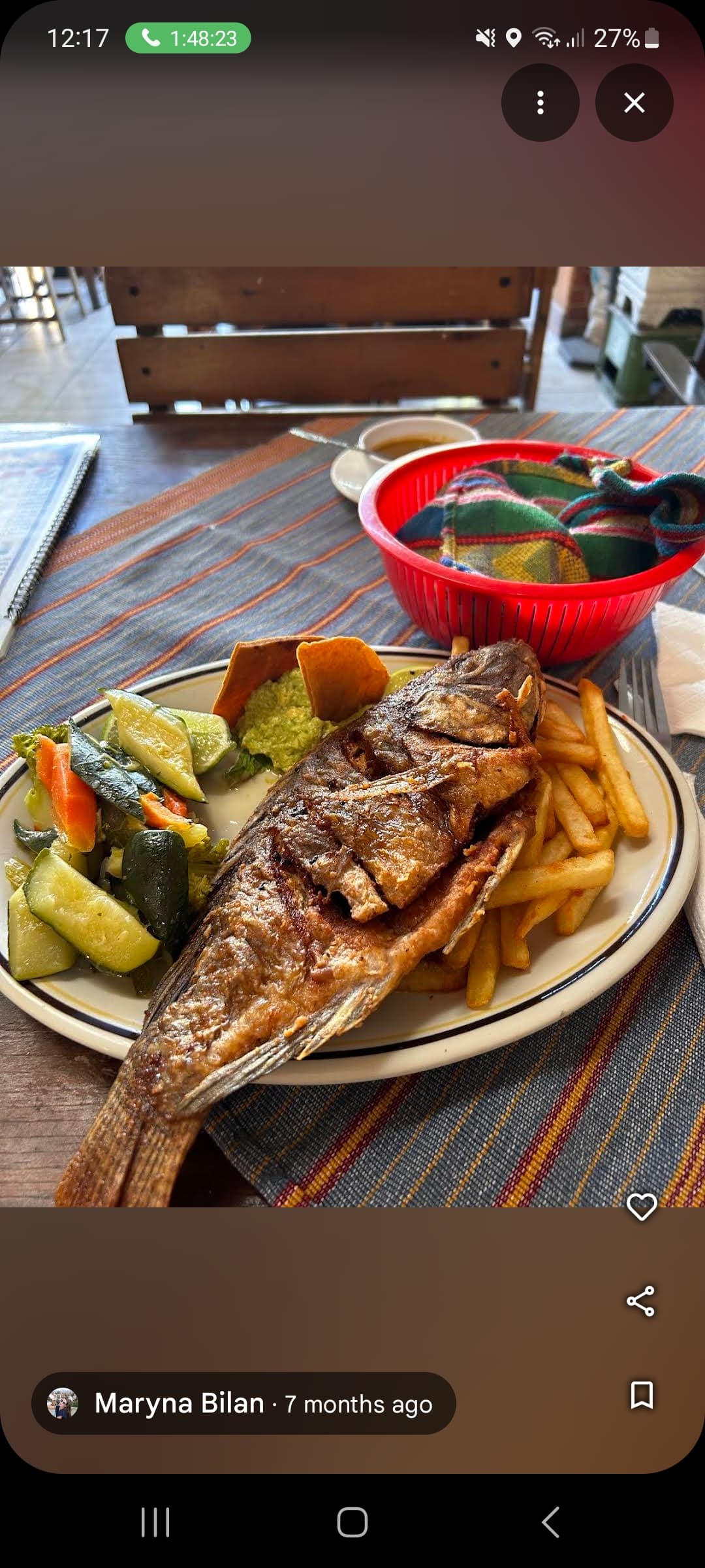 Pescado frito entero con papas fritas y vegetales